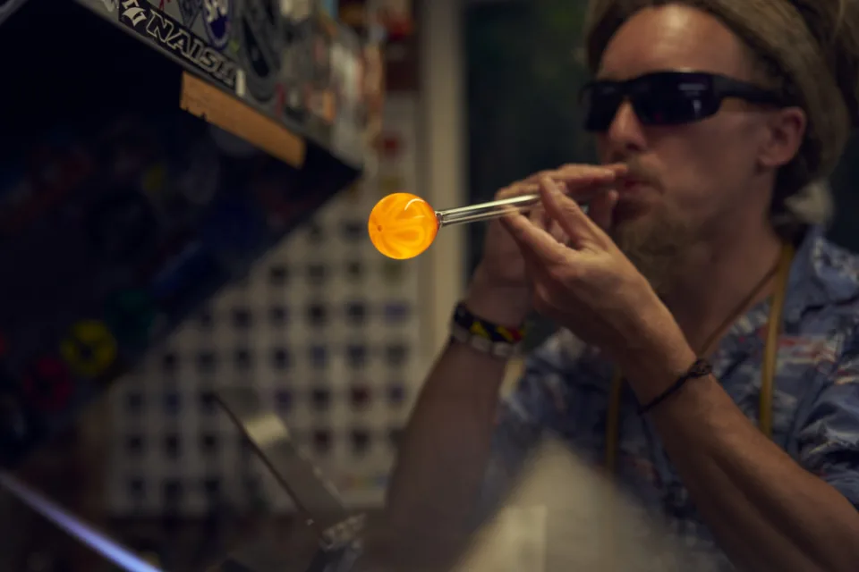 Peter blowing a bubble in hot glass